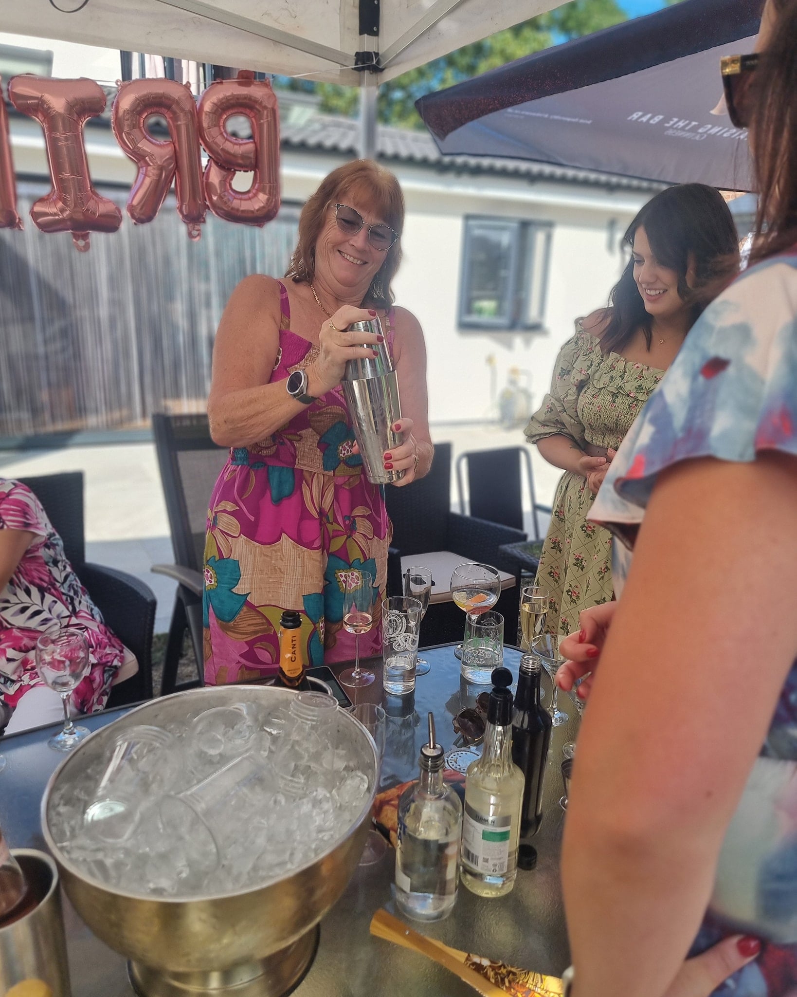 Guest enjoying hands-on cocktail making classes in Essex, measuring ingredients with precision during a vibrant hen party event.