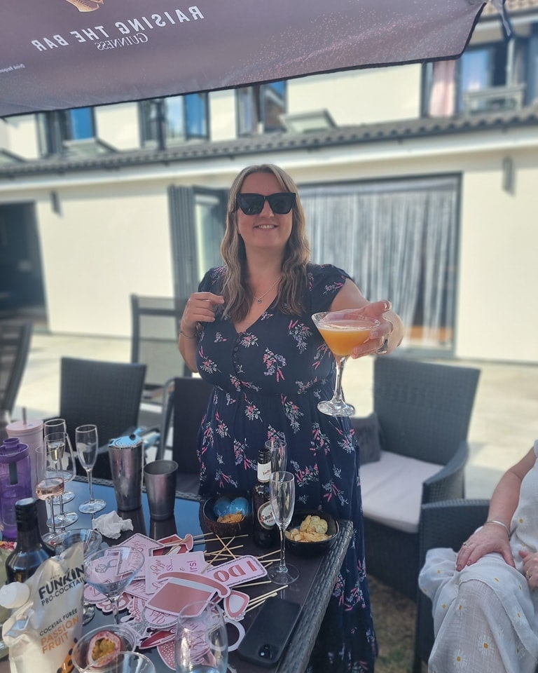 Hen party guests shaking cocktails during a fun and interactive cocktail making class in Essex.